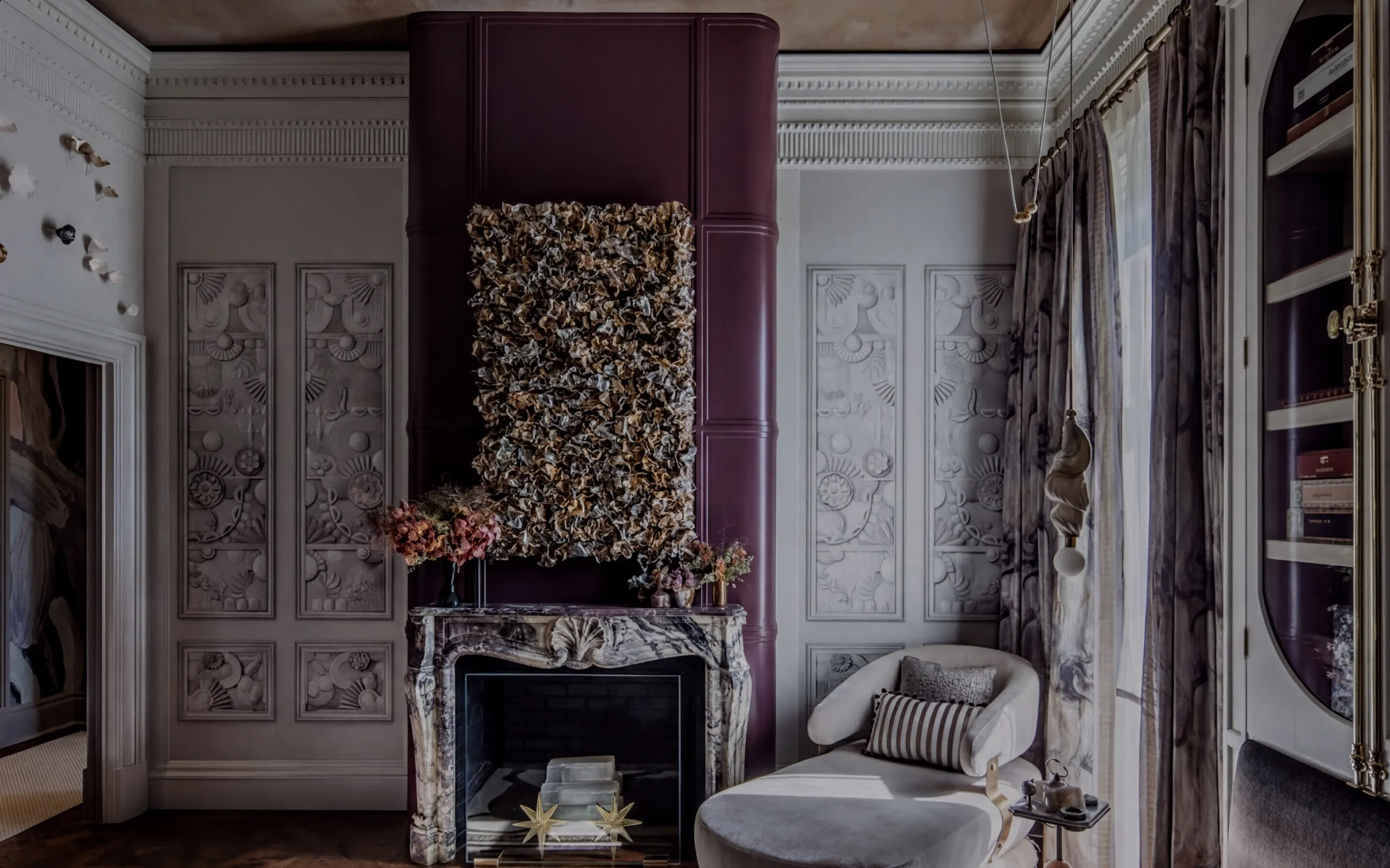a living room with an elegant chair and a fireplace